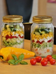 Glass jars with mixed salad, ready to go