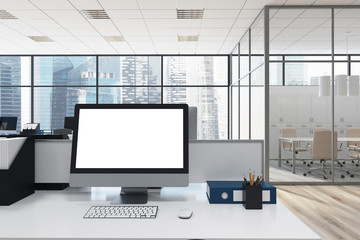 White computer monitor in a modern office