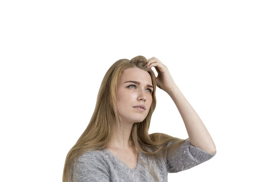 Blonde woman scratching head, isolated