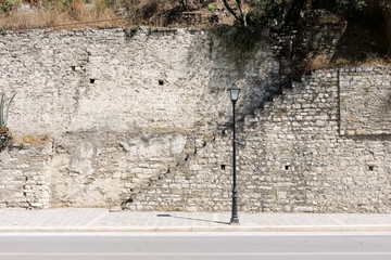 lamp pos, sairst and medieval stone wall in Berat city, Albania