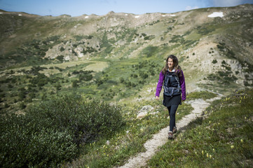 Naklejka na ściany i meble Woman Walking in Rocky Mountains
