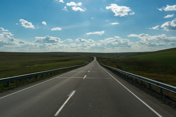 Beautiful clouds and empty straight road