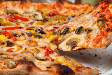 Supreme pizza lifted slice