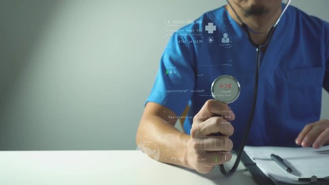Modern medical concept.Smart medical doctor working with stethoscope and futuristic computer on desk in modern office with VR graphic icon interface in 4K (UHD)
