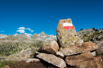 Trail sign along mountain trail.