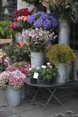 the Various flowers at the entrance to the store for sale for various occasions: weddings, birthdays, mother's day, Valentine's Day