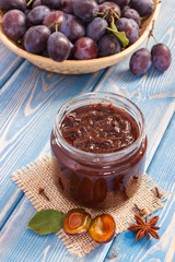 Homemade plum jam with fruits in wicker basket, healthy dessert concept