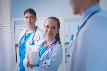 Young team or group of doctors standing in hospital