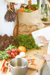 Young woman cutting vegetables in the kitchen