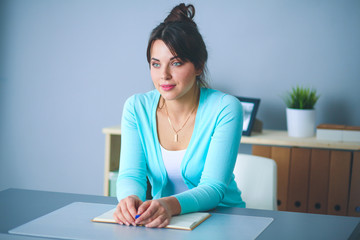 Portrait of businesswoman sitting at desk