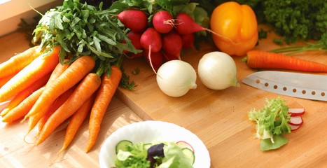 Young woman cutting vegetables in the kitchen