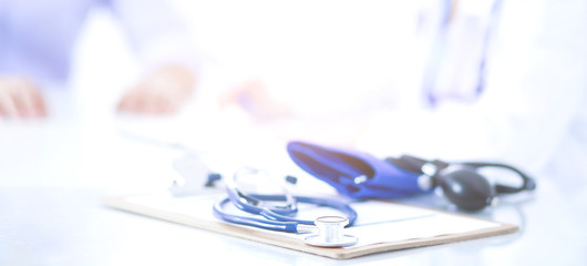Doctor woman sitting with male patient at the desk