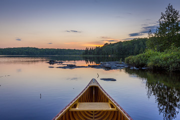 Bow of a cedar canoe on a lake at sunset - Ontario, Canada