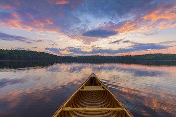 Bow of a cedar canoe on a lake at sunset - Ontario, Canada - obrazy, fototapety, plakaty