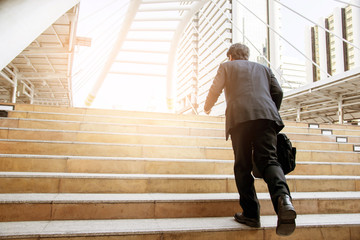 Businessman walking the stairs with city background, Businessmen go to success concept.