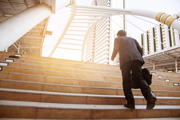 Businessman walking the stairs with city background, Businessmen go to success concept.