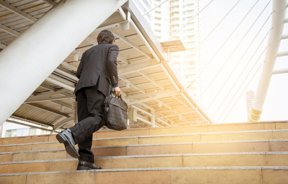 Businessman walking the stairs with city background, Businessmen go to success concept.