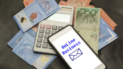 Paper money, caculetor, utility bills and smartphones with ONLINE BUSINESS, the online business concept.