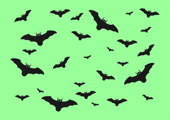 Halloween bats isolated on green background.
