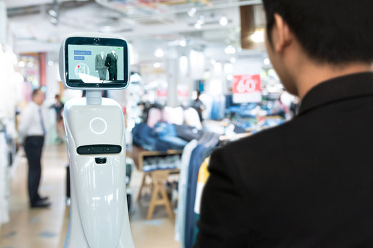 Robotics Trends technology , smart retail business concept. Autonomous personal assistant robot for navigation customer to search items in fashion shopping mall.