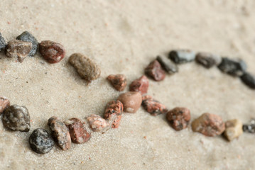 pebble infinity symbol on sand  selective focus