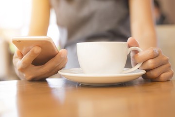 Women are drinking coffee She uses the phone to communicate. Concept, working women, technology, business cafe