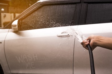 Sprinkle with water to wash the car by hand. Car wash concept