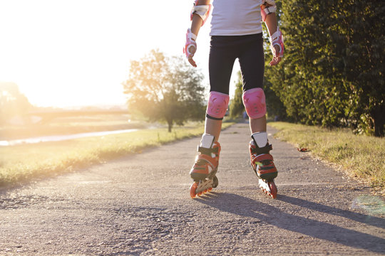 Close up of girl rollerblading in park. Outdoor, recreation, lifestyle, rollerblading.