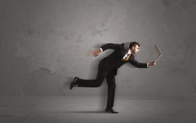 Running businessman with device in hand