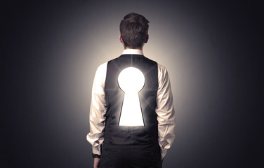 Man standing with black keyhole on his back