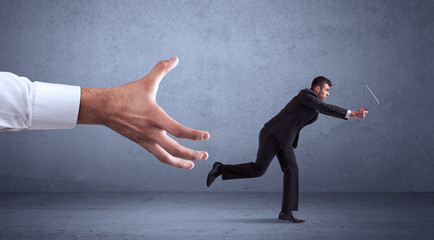 Businessman running from hand