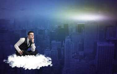 Man sitting on a cloud above the city