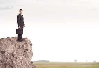 Happy salesman on cliff in the country