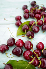 cherries on a turquoise wooden surface