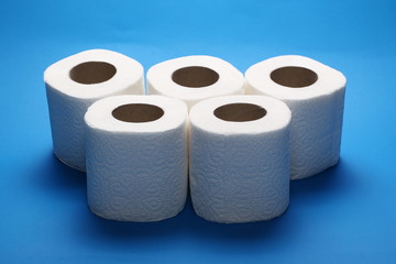 Toilet paper rolls isolated on blue background