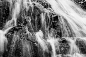 Fototapeta na wymiar Water flowing over stones