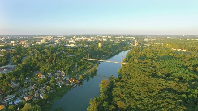 Aerial Paraplane hang glider in the air above river city canyon