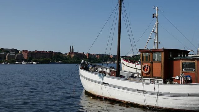 Traditional fishing boat with cruise at the background in Stockholm Sweden