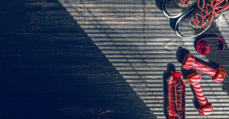 Sneakers dumbbells and a bottle of water. Flat view. All in one color.