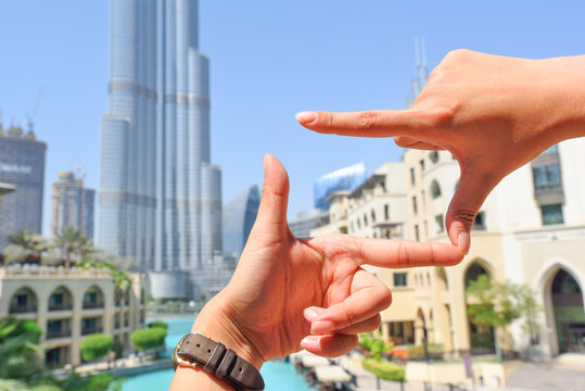 finger hand symbols concept framing composition for taking a photo Viewfinder with dubai downtown background