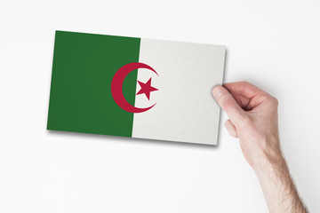 Male hand holding algeria flag