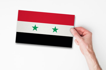 Male hand holding syria flag