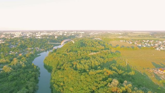 Aerial Paraplane hang glider in the air above river city canyon