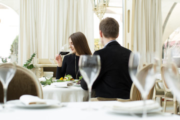 Beautiful woman drinking wine at the restaurant