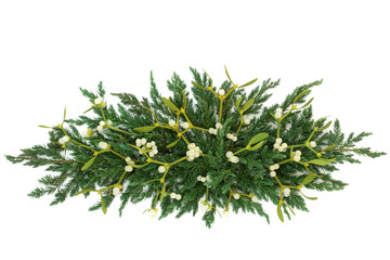 Mistletoe and juniper fir forming a decorative winter greenery display over white background.