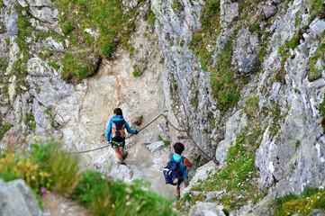 Obraz premium Tourists hiking in mountains - Slovakia, Hight Tatras