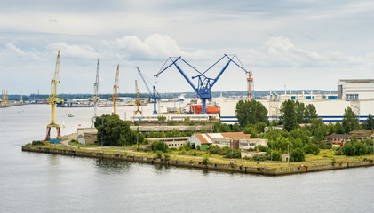 Fototapeta na wymiar old harbour area in warnemuende with shore cranes