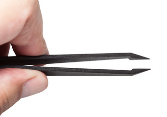 fingers hold plastic tweezers with sharp tips - obrazy, fototapety, plakaty
