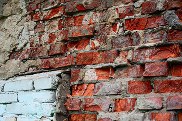 Background of a broken brick red and white wall