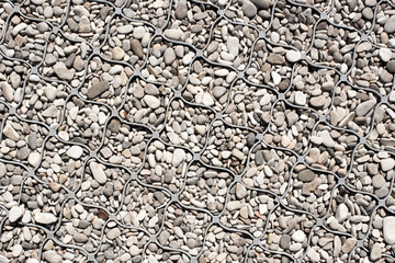 Textured plastic paver with in it pebbles close